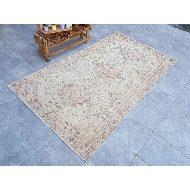 A Turkish handmade vintage Anatolian Oushak rug. We collect old vintage antique rugs from Anatolia, which is the eastern...
