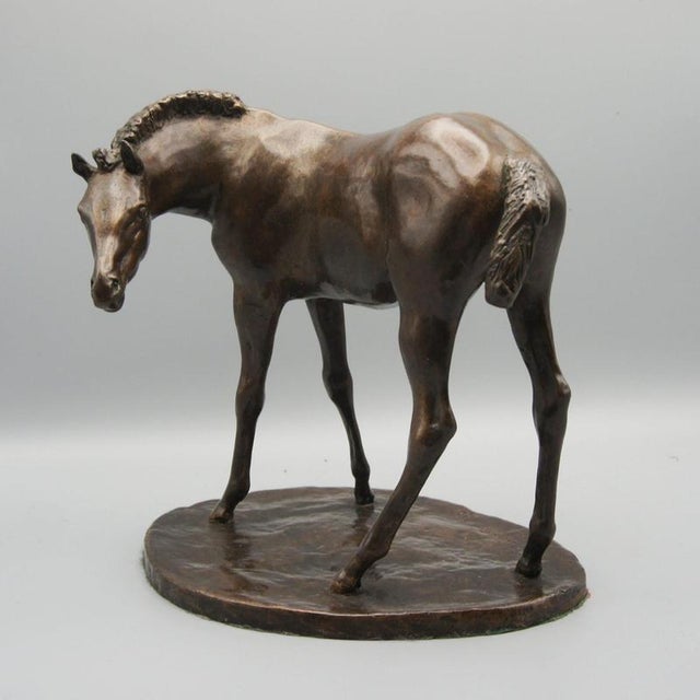 A charming bronze sculpture of a foal with head turned by john rattenbury skeaping. Signed and numbered 8/20. Dimensions:...