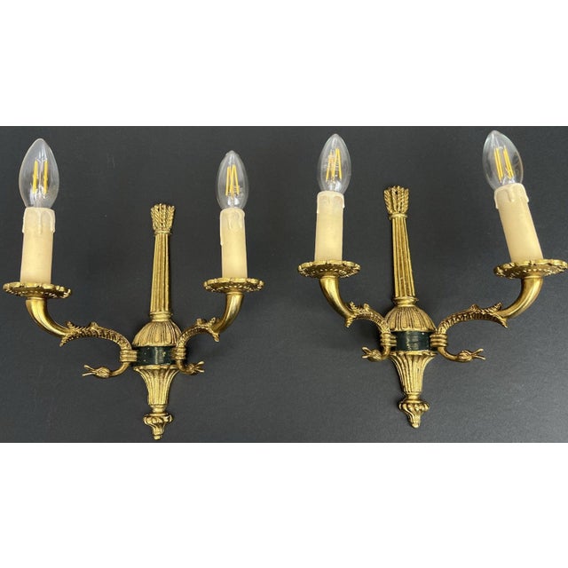 A charming pair of Vintage French sconces featuring elegant twin arms and beautifully detailed decorative styling. These...