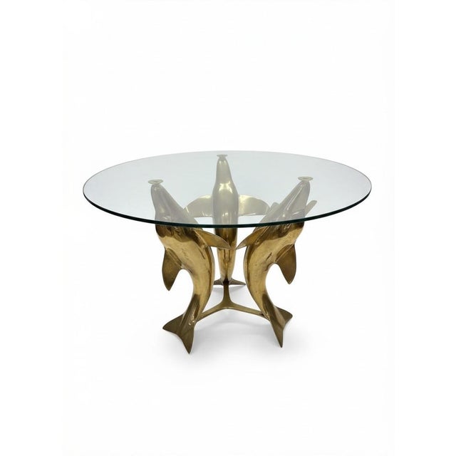 This Vintage Brass Dolphin End Table Coffee Table with a Glass Top is a stunning piece of Mid-Century Modernism furniture....