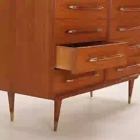 Elegant 8-drawer dresser or sideboard in the style of T.H. Robsjohn-Gibbings. The piece features eight solid oak drawers,...