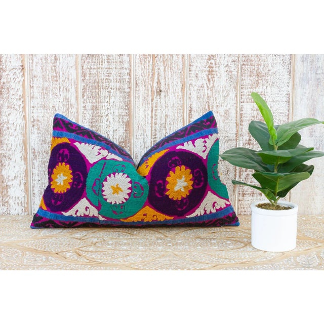 Made from a vintage Suzani tapestry, it features hand done embroidery and a solid linen back. Suzani is a Persian word...