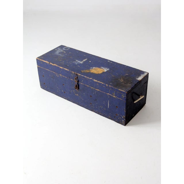 This vintage wooden toolbox is a functional and stylish storage piece with rustic charm. The long blue wood chest features...