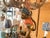 Charming and Whimsical six-light chandelier featuring a beautifully detailed monkey figure climbing a tree trunk, creating...