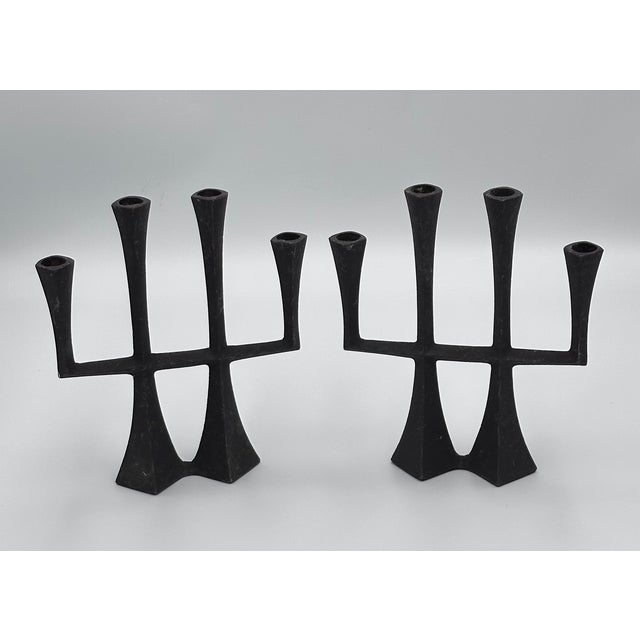 Discover a magnificent set of mid-century design with this stunning vintage cast iron candelabrum, attributed to the...
