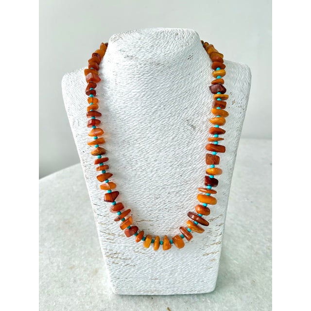 Gorgeous Baltic Amber necklace with turquoise beaded spacers, gold tone metal clasp. Vintage amber beads were used to...