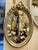 Elegant French-style oval wall mirror featuring a richly hand-carved frame with intricate ornamental detailing and a...