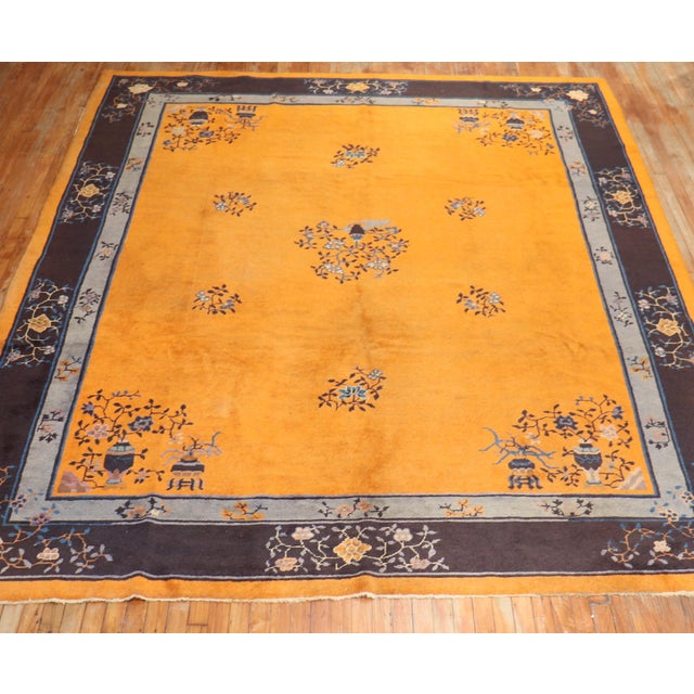 A room-size tradtional Chinese rug with a rare pumpkin color ground Measures: 9' x 11'6''.