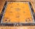 A room-size tradtional Chinese rug with a rare pumpkin color ground Measures: 9' x 11'6''.