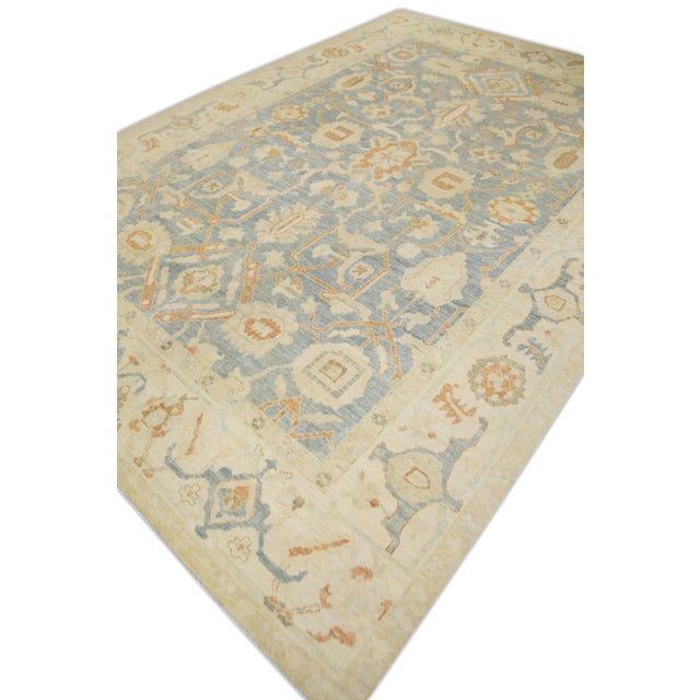 This modern fine woven Turkish Oushak rug is a stunning piece of art that has been handwoven using traditional techniques...