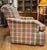 Pair of upholstered club chairs with pink and green plaid fabric design. Designer chairs made by Persnickety Furniture...