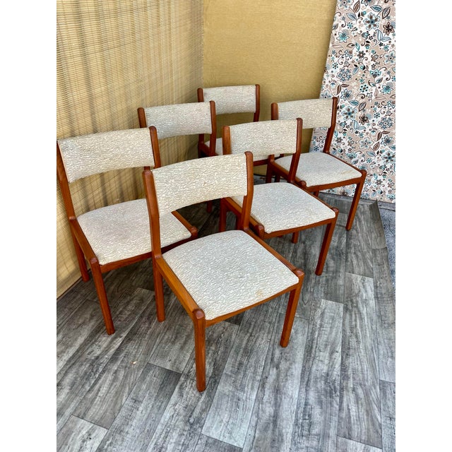 A set of Six Mid-Century Danish Modern Dining Chairs by J.L. Moller-Hojbjerg, Denmark. C. 1980s Features a solid teak...