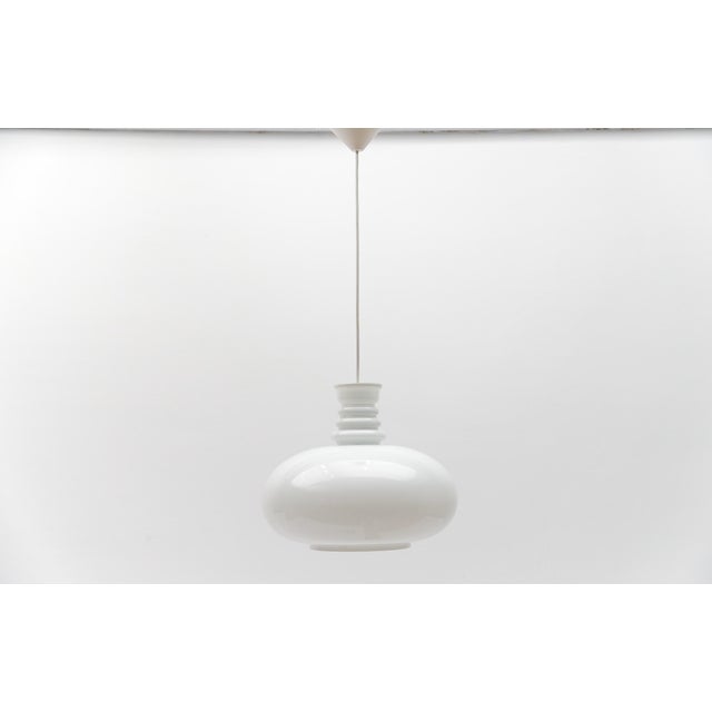Lovely white glass ceiling lamp by peill & putzler, 1960s the cable length with lamp is 110 cm in total, adjustable down...