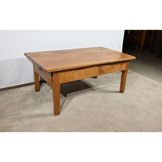 Solid cherry regional work table consisting of a drawer at each end. These protruding drawers open using a wood button....