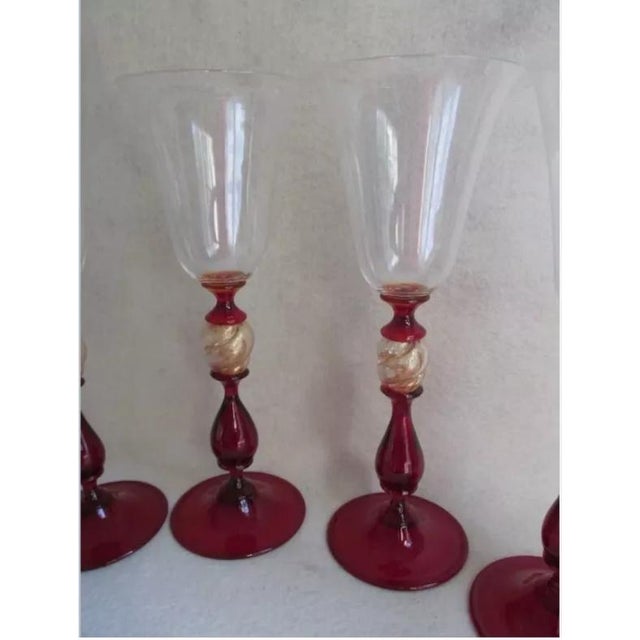 A set of 4 Venetian Glass Wine Flute of Water Goblets. All four glasses are signed, the words are hard to decipher but...