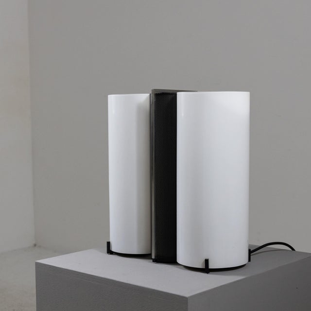 70s table lamp made with a double diffuser in Murano milk glass with a black mesh metal structure in between which...