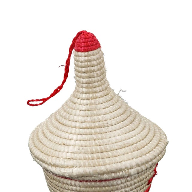 The Tutsi Tight Weave Basket with Lid from Rwanda epitomizes the artistry and tradition of the Tutsi community's weaving...