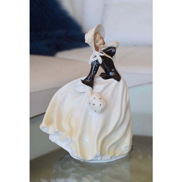 ROYAL DOULTON "AUTUMN BREEZES" FIGURINE Era: Mid-20th Century (circa 1950s-1960s) Style: Mid-Century Figurative OVERVIEW:...