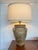 Olive and taupe glazed pottery table lamp. Features earth tone glaze and three handle at the side. Wood top and base.