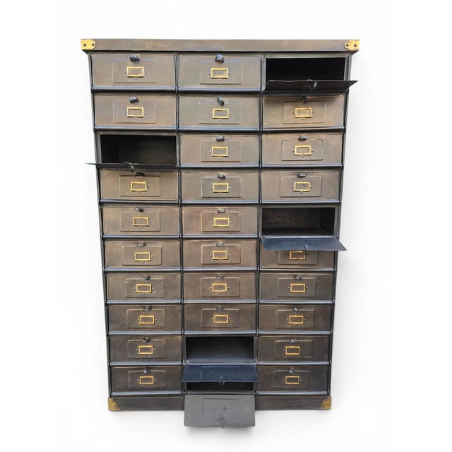 A monumental French industrial filing cabinet manufactured by the renowned Strafor (Forges de Strasbourg), dating from the...