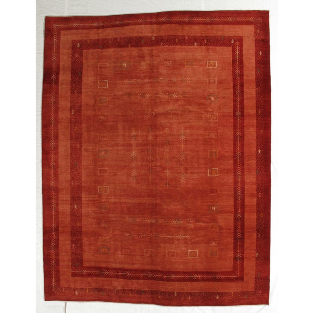 Vintage hand-knotted Persian Fine Lori Gabbeh rug featuring a rich terracotta field with layered borders and subtle tribal...