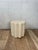 A striking sculptural side table, or pedestal, featuring a deeply textured hand-finished surface and dramatic scalloped...