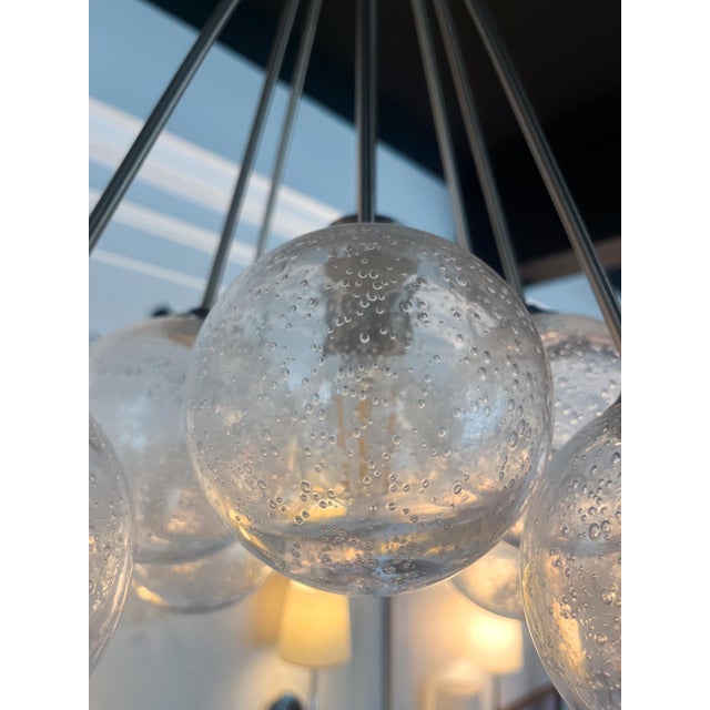 This stunning light features one light bulb and 8 seeded glass bulbs to catch and disperse the light. Although it's small,...