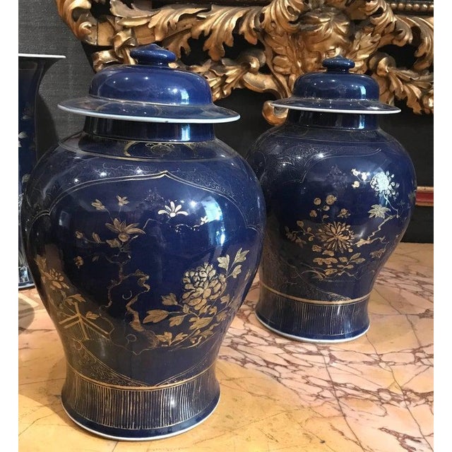 Pair of Chinese 18th Century powder-blue gilt-decorated jars. Each gold painted with a composite floral patterns. Measure:...