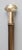 A superb antique English walking stick with a repoussé brass handle, walnut shaft, and brass ferrule, circa 1920. This...