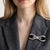 An antique platinum ribbon bow brooch from circa 1910 — an object of extraordinary delicacy and technical refinement, in...