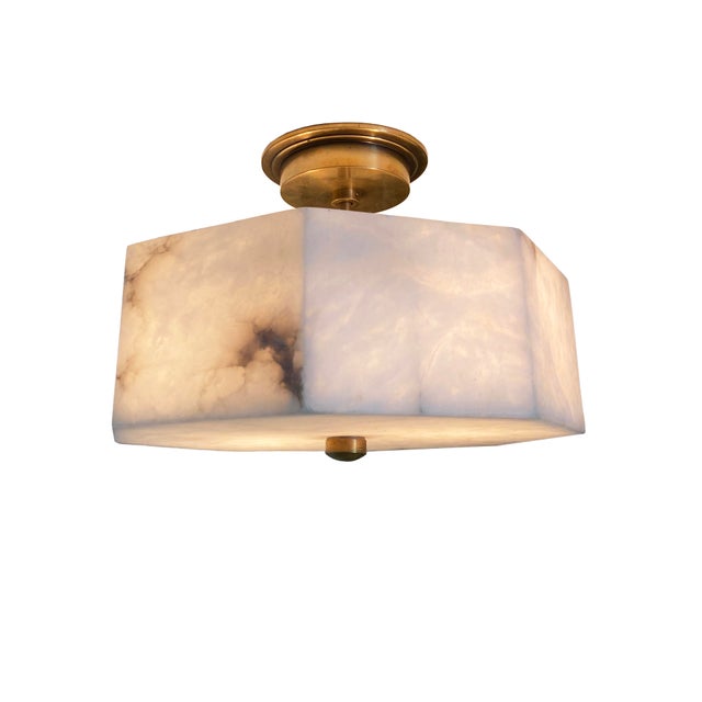 Elevate your interior with the understated elegance of this alabaster and brass flush mount ceiling light. Featuring a...