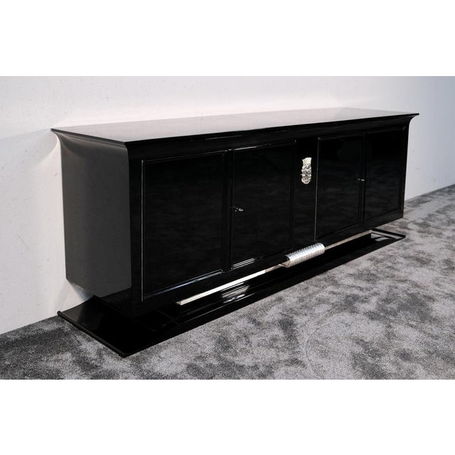 Art Deco High-Gloss Black Lacquered Sideboard with Stylized Woman's Head Emblem, 1930s, in Restored conditions. Designed...
