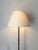 A striking post-modern design floor lamp in a gunmetal tone. This iron standard lamp has an elegant form with decorative...