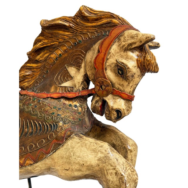 Large vintage paper mâché carousel horse sculpture featuring richly hand-painted detailing, antiqued gilt accents, and...