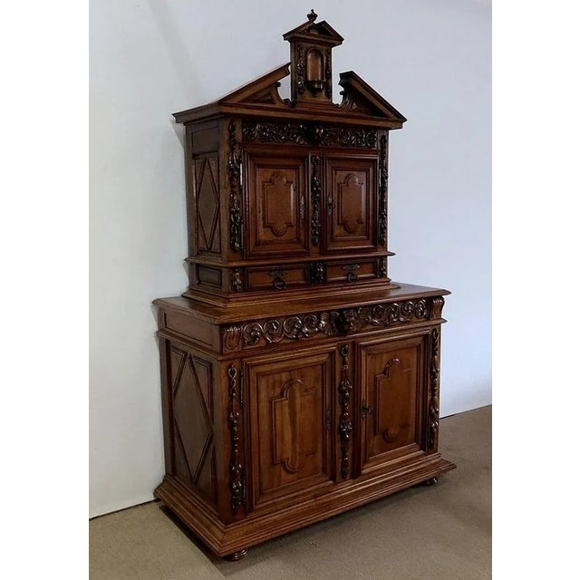 Piece of furniture two-body Renaissance period in solid walnut in the Renaissance taste richly molded and carved with...