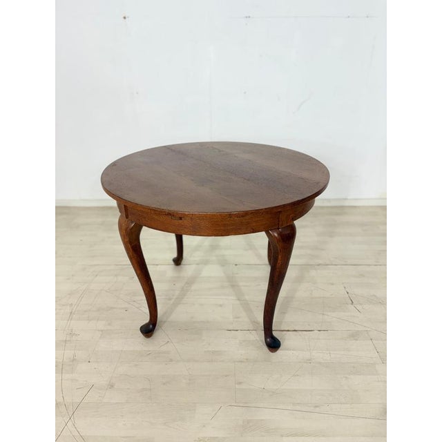 For sale is a round, extendable Chippendale dining table. with its warm wood tones and characteristic, elegantly curved...