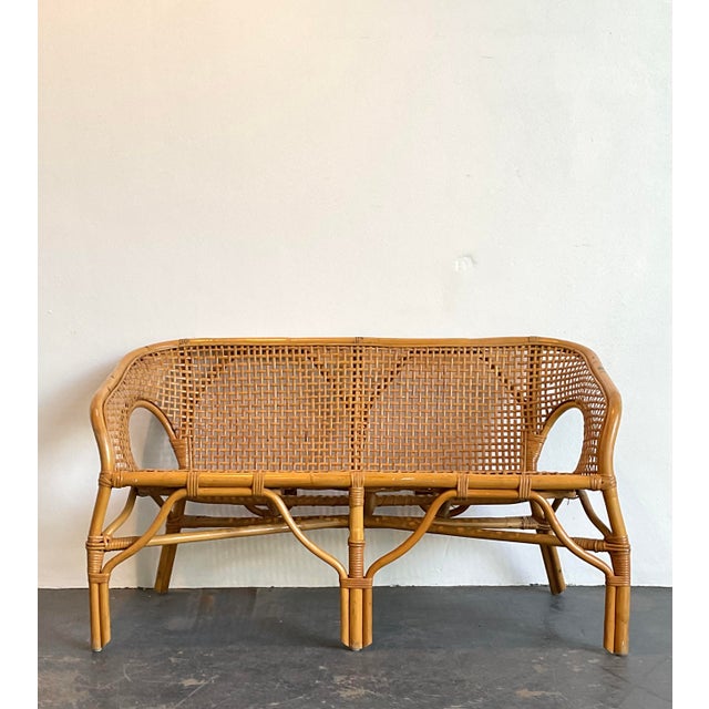 This vintage woven rattan settee captures the essence of coastal elegance and bohemian flair, blending organic textures...