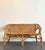 This vintage woven rattan settee captures the essence of coastal elegance and bohemian flair, blending organic textures...