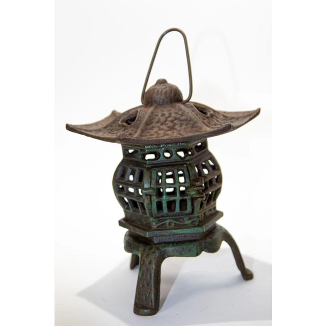 Japanese iron pagoda garden candle lantern. Hand cast iron Japanese candle lantern with hearts on top. Can rest on table...