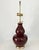 A single extra large double gourd ceramic lamp in a glossy oxblood or sang de boeuf red glaze by Ralph Lauren. Solid brass...