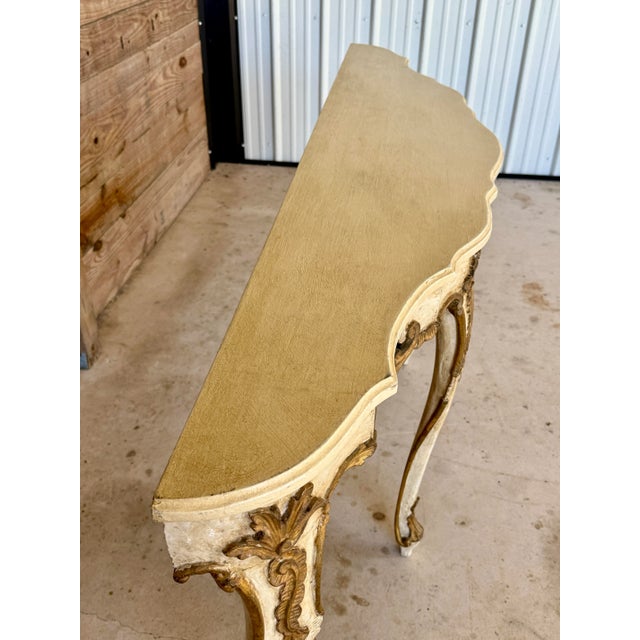An exquisite late 19th century Italian hand-carved giltwood and painted console table in the Rococo Revival style, richly...