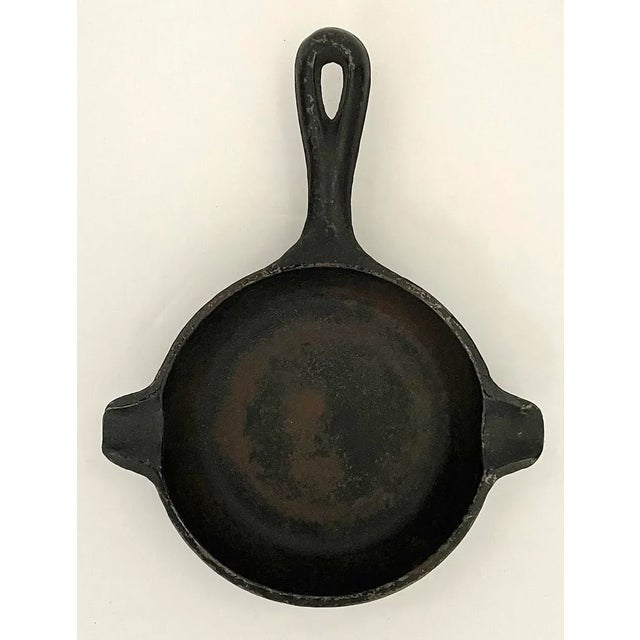 Real mini cast iron skillet ashtray made by Wagner Ware. Ashtray has 2 cigarette rests.