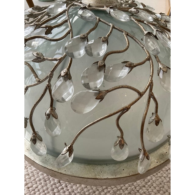 Ceiling lightfixture with a gilded metal tree branch and glass leaf design