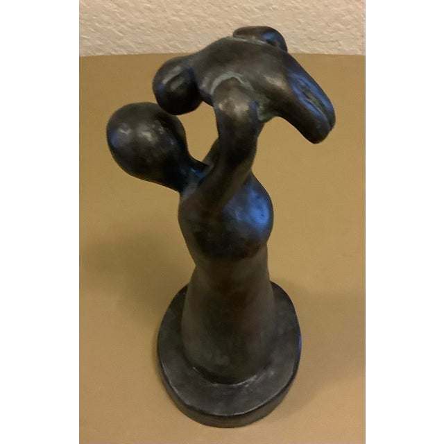 This lovely statue figurine is a joyous display of mother and child. It feels like it could be wooden...it's smooth. The...
