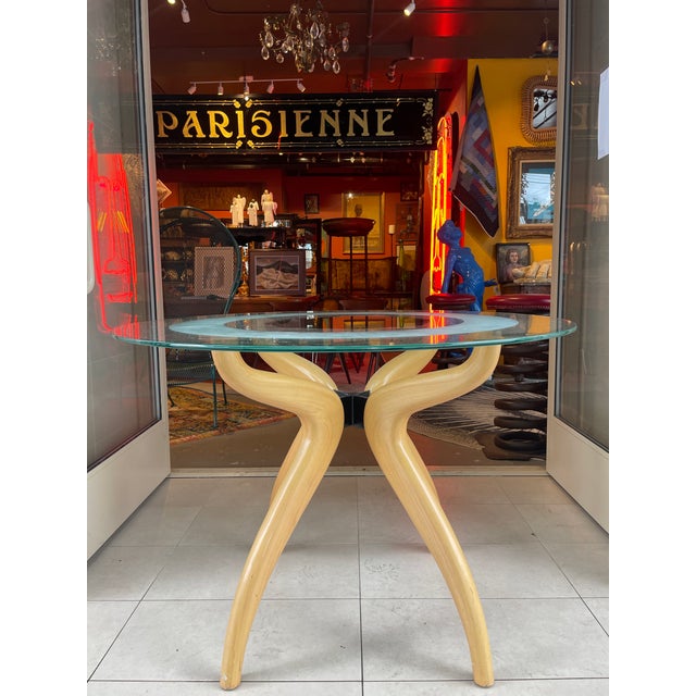 This is a versatile round Italian dining table from the 1980s. The beveled glass top has a frosted band in the interior...