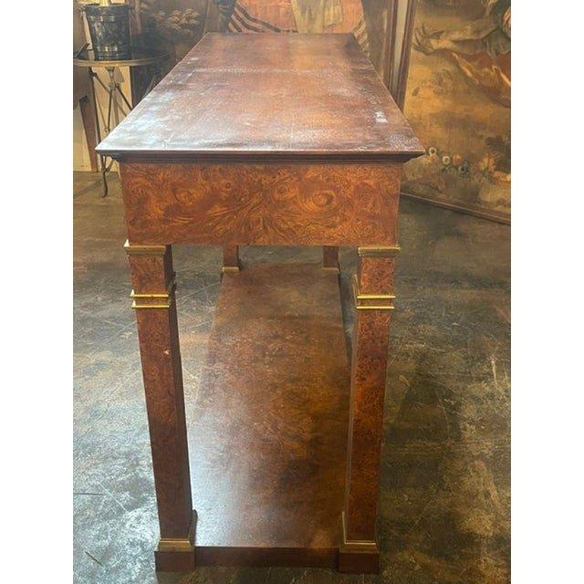 The Vintage Baker Empire Style Burl-wood Console is a luxurious piece of furniture that exudes elegance and...