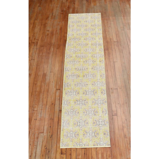 A mid 20th Century hand-knotted one of a kind Turkish runner predominantly light yellow.