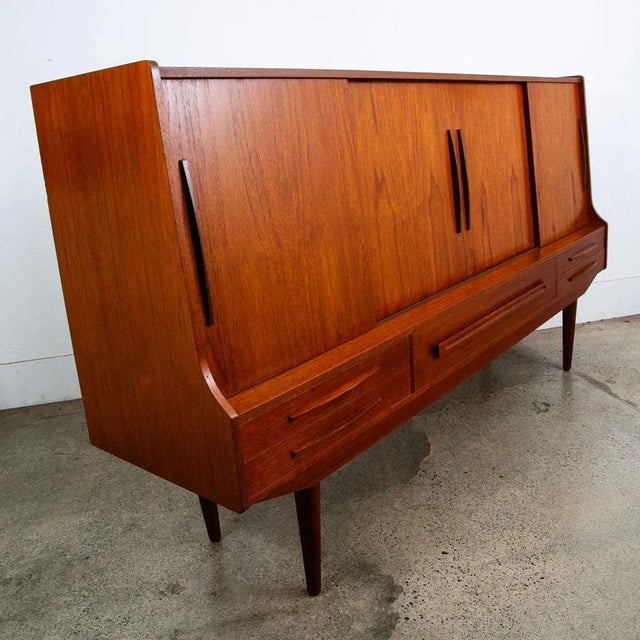 Classic Danish design high-board made from teakwood and imported from Denmark. Clean minimalist style throughout. Comes...