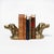 Pair of cast brass bookends modeled as the heads of spaniels, or gun-dogs, and worked as opposing profiles. Long pendant...