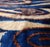 "A refined study in movement and tone, this handcrafted lumbar pillow captures the fluid rhythm of hand-dyed textiles...